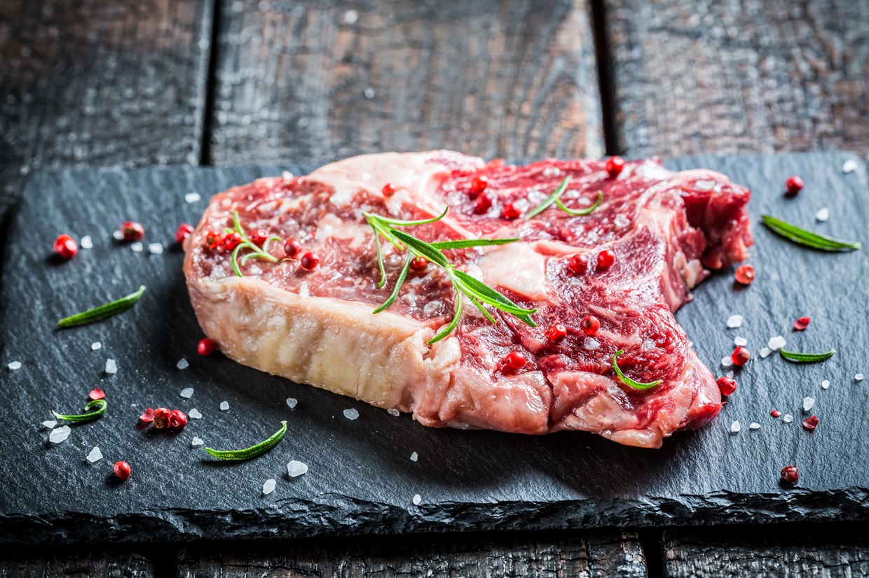 Beef with rosemary and pepper on black rock